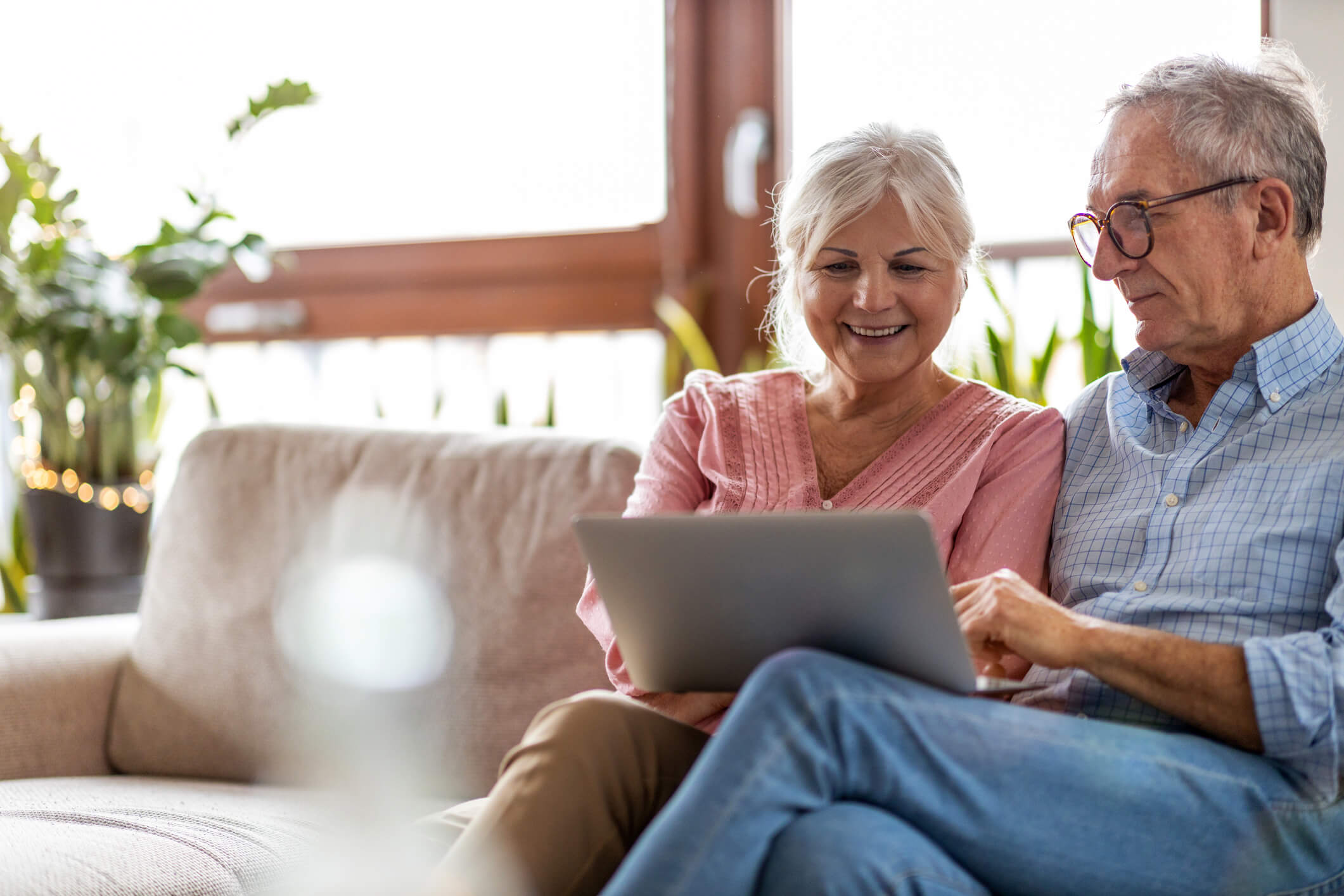Older couple sitting on a couch improving their retirement planning