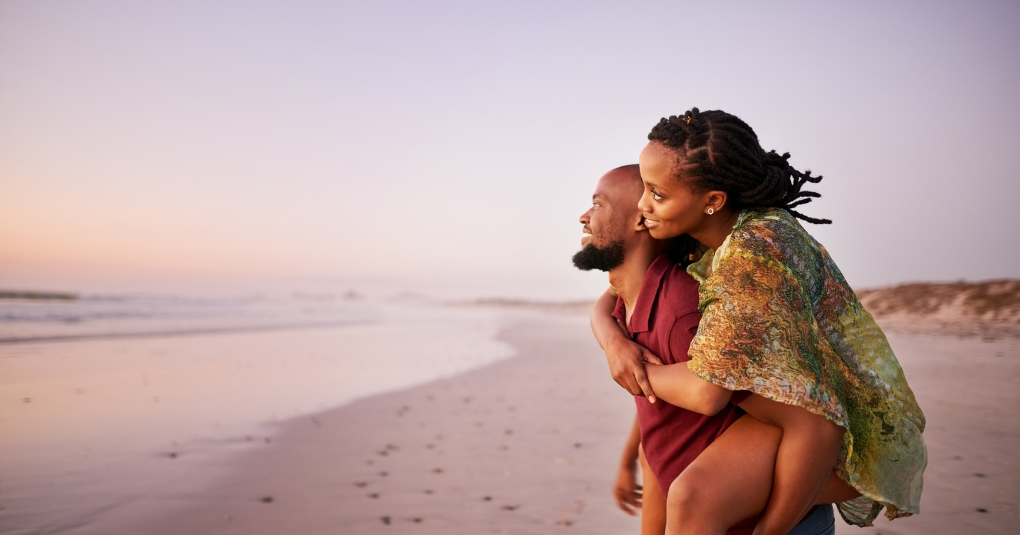 Couple hugging on the beach.