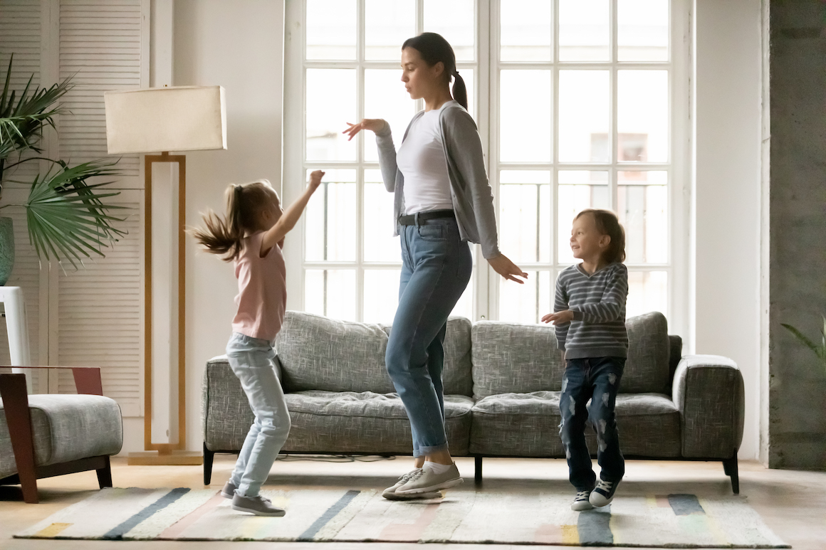 Mom dancing with kids in living room